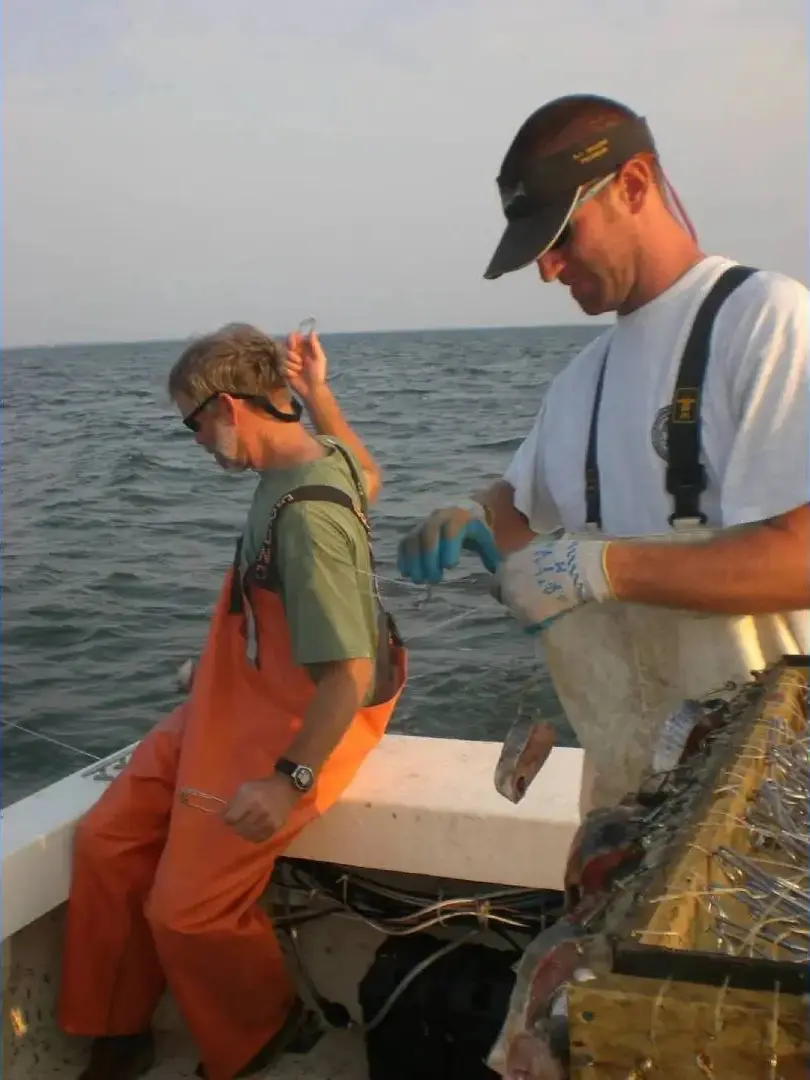 Two crew members set a longline for the North Carolina Coastal Trawl Survey. Lee Paramore, North Carolina Department of Environmental Quality.